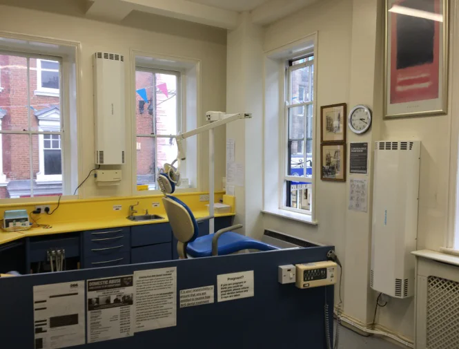 MT250 wall-mounted UV-C air purifiers installed in Pride Hill Dental Surgery treatment room with dental chair and equipment